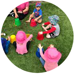 Modern image of children sitting in circle playing